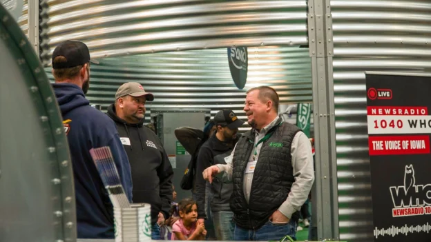 A Sukup representitive converses with guests at the Iowa Ag Expo.
